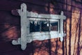 Routed window on an old wall with shadows from trees Royalty Free Stock Photo