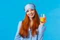 Daily routine, morning and healthy lifestyle concept. Attractive energized redhead female in nightwear, sleep mask