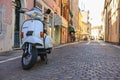 Rovigo, Italy 29 july 2022: Scooter Vespa parked on old street in Rome, Italy