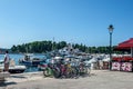 Rovine, Croatia, August 30, 2018. Tourists walk along the central square past a large bicycle parking lot in the