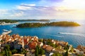 Rovinj city skyline overlooking the orange rooftops of old houses, the picturesque harbor and islands