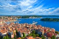 Rovinj city skyline overlooking the orange rooftops of old houses, the picturesque harbor