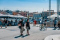 ROVINJ, CROATIA-AUGUST 30, 2018: Tourists walk by the Fountain with a sculpture of a boy and a fish and a clock Tower on Royalty Free Stock Photo