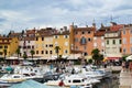 Rovinj, Croatia; 7/18/2019: Facades of the typical croatian colorful houses in the port of Rovinj, Croatia, with a lot of boats at