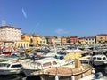 A view of the waterfront of Rovinj, Croatia full of colourful old buildings and boats docked in the bay.