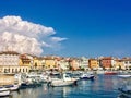 A view of the waterfront of Rovinj, Croatia full of colourful old buildings and boats docked in the bay.