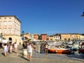 A view of the waterfront in the old town of Rovinj, Croatia. Tourists walking around and taking photos on a beautiful sunny day.