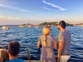 A young couple look for dolphins during an evening dolphin watching tour outside of the beautiful Rovinj, Croatia Royalty Free Stock Photo