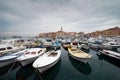 Rovinj, Croatia. Motorboats and boats on water in port of Rovinj. Medieval vintage houses of old town. Yachts landing, tower with Royalty Free Stock Photo