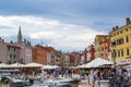 Rovinj, Croatia; 7/18/2019: One of the main streets of the old town of Rovinj, with colorful houses on both sides and boats in the