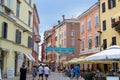 Rovinj, Croatia; 7/18/2019: One of the main streets of the old town of Rovinj, full of people and terraces of bars, with colorful