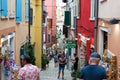 Rovinj, Croatia; 7/18/2019: Picturesque narrow street with colorful facades of the houses and people walking