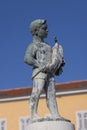 Boy with Fish fountain on Marshal Tito Square in front of Tower with city clock, Rovinj, Croatia Royalty Free Stock Photo