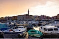 Rovinj, Croatia; 7/18/2019: Sunset in Rovinj, with a lot of boats anchored in the port and the old town at the background, with