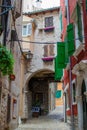 Rovinj, Croatia; 7/18/19: Traditional street through an arch in the old town of Rovinj, with the facade of typical croatian old
