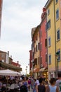 Rovinj, Croatia; 7/18/2019: Vertical picture of one of the main streets of the old town of Rovinj, full of people and terraces of