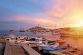 Rovinj, old costal town of Croatia in golden sunrise light. Motorboats, boats and yachts on water in port of Rovinj. High tower of Royalty Free Stock Photo