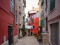 Narrow cobblestone street with hanging laundry in Rovinj, Istria, Croatia