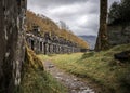 Row of abandoned old miners cottages in slate mine quarry Dinorwic North Wales. Eerie derelict barracks left behind on mountain Royalty Free Stock Photo