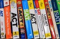 Row of ACT and SAT books contain standardized practice tests for university admissions in USA