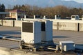 A row of air conditioning units on a rooftop. Royalty Free Stock Photo