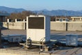 A row of air conditioning units on a rooftop. Royalty Free Stock Photo