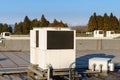 A row of air conditioning units on a rooftop. Royalty Free Stock Photo