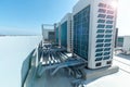 A row of air conditioning units on rooftop with blue sky Royalty Free Stock Photo