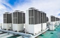 A row of air conditioning units on rooftop with blue sky Royalty Free Stock Photo