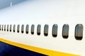 A row of airplane windows, portholes. Outside view.