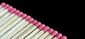 Row of aligned fire matchsticks on black background