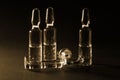 Row of ampulas with medicine on dark sepia background Royalty Free Stock Photo