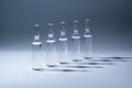 Row of ampules with medicine on blue background Royalty Free Stock Photo