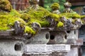 A row of ancient moss-covered stone lanterns in a Japanese temple Royalty Free Stock Photo