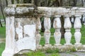 Row of ancient stone railings in city park close up. Ruined long of period.