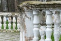 Row of ancient stone railings in city park close up. Ruined long of period.