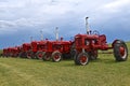 Row of antique Farmall red tractors