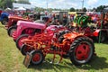 A row of antique farming tractors.