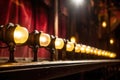 row of antique footlights illuminating a theater stage Royalty Free Stock Photo