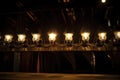 row of antique footlights illuminating a theater stage Royalty Free Stock Photo
