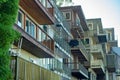 Row of apartment buildings of town homes in city or suburban area in late afternoon shade with cloudy sky above Royalty Free Stock Photo