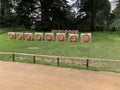 Row of archery targets in green field, forest in background Royalty Free Stock Photo