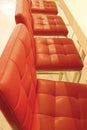 A row of armchairs with red leather seats Royalty Free Stock Photo