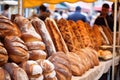 a row of artisanal loaves of bread at a food market Royalty Free Stock Photo