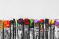 Row of artist paintbrushes with colorful bristle closeup Royalty Free Stock Photo