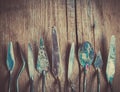 Row of artist palette knifes on old wooden rustic backdrop. Royalty Free Stock Photo