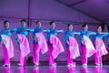 Row of Asian women performing fan dance on stage Royalty Free Stock Photo