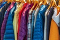 Row of autumn coats hanging on rack, shopping. Cloth shop, clothing store, female and male collection in a outfit store Royalty Free Stock Photo