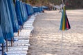 row of beach beds with blue umbrellas Royalty Free Stock Photo