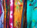 Row of beautiful colorful handmade scarves from felted wool close up